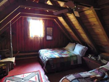 interior of cabin with beds with quilts