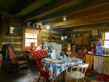 interior of Aunt Phoebe's cabin with table, chairs, rocker